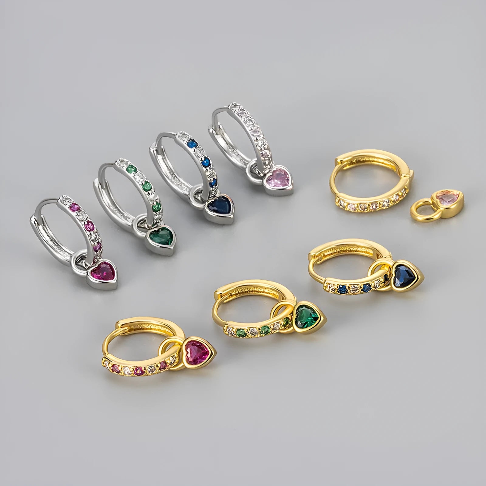 Women's gold-coloured heart drop earrings with a blue zircon stone centre and clip-on fastening.