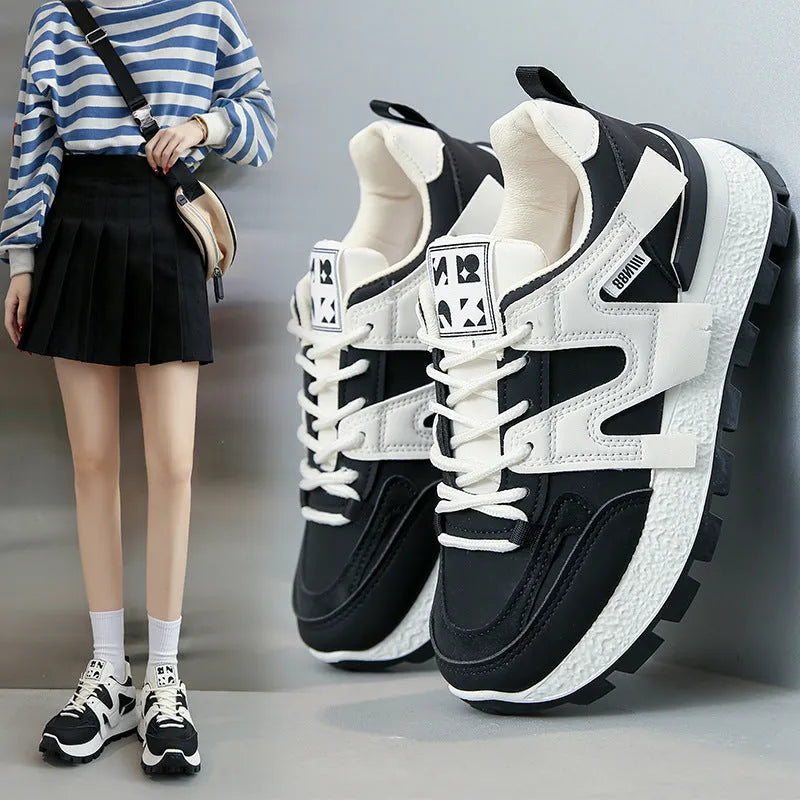 Women's white low-top running sneakers with round toe and lace-up closure on rubber sole