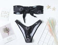 Black printed one-piece swimsuit with backless design and split tube top.