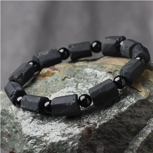 Natural black tourmaline rough stone bracelet showing authentic crystal texture on approximately 9mm beads