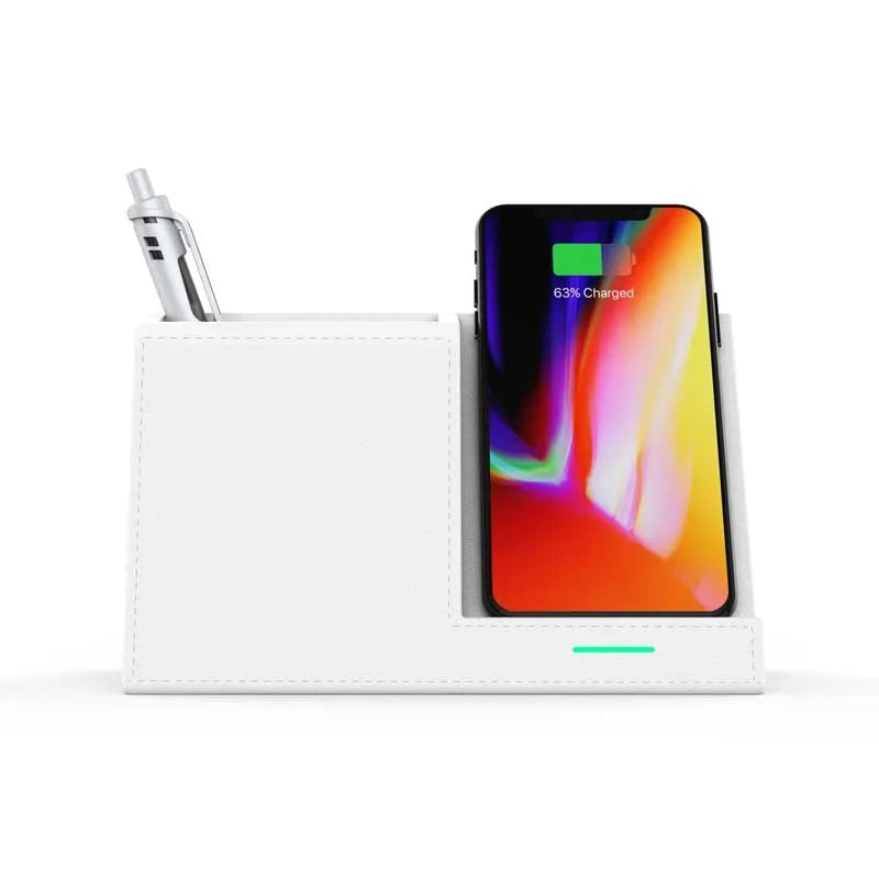 Black leather pen holder with integrated wireless phone charging pad on a desk.