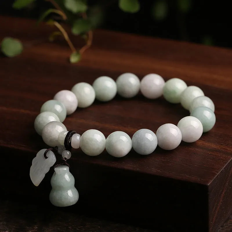 Natural jade bracelet with geometric pendant and hanging charms including Maitreya Buddha, gourd, and double apple designs