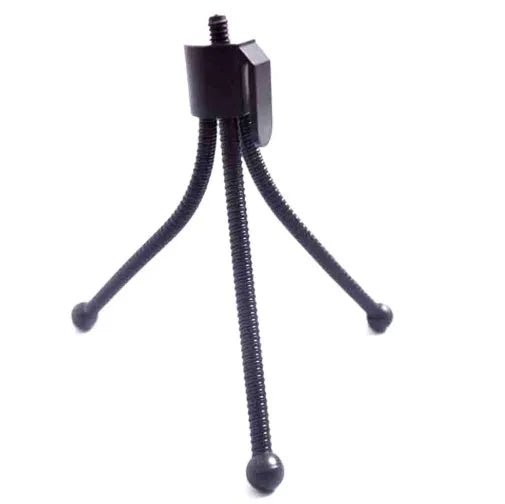 Small silver iron mini tripod with ball head, folded to compact size next to a smartphone.