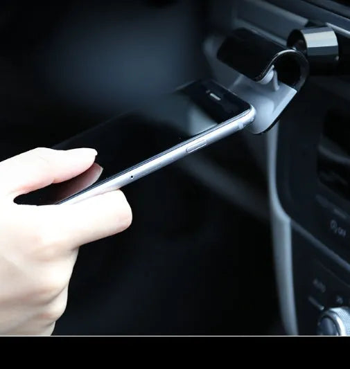 Black universal car phone holder with 360-degree rotation ball joint mounted on dashboard
