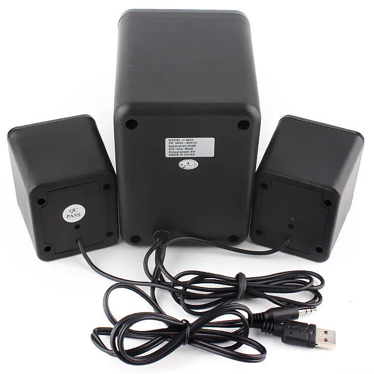 Green 2.1 USB computer speaker with colourful glowing lights on a desk.