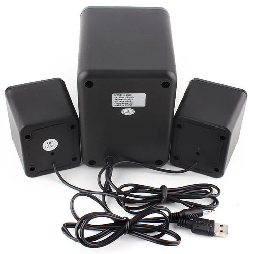 Green 2.1 USB computer speaker with colourful glowing lights on a desk.