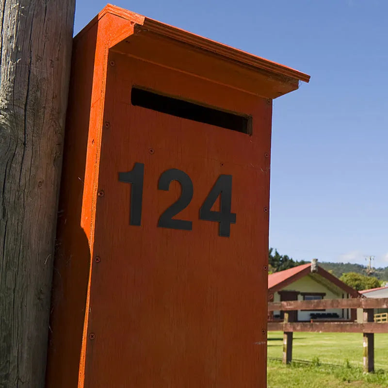 Black stainless steel adhesive house numbers and letters, each 7.5cm tall, for property identification.