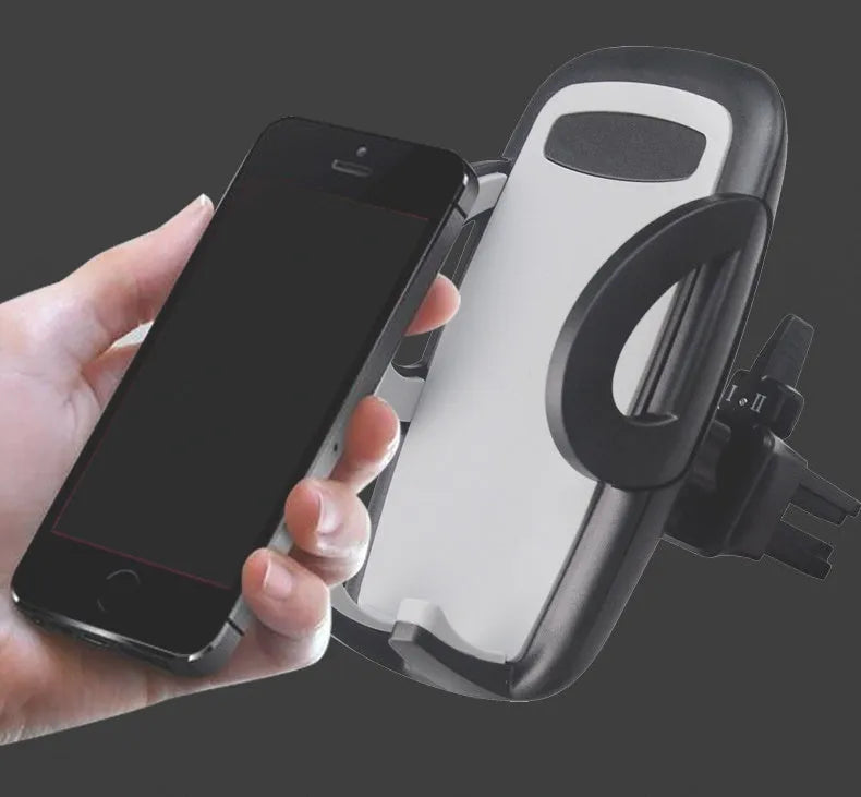 Black plastic car air vent mobile phone holder mounted on a car vent, holding a smartphone.