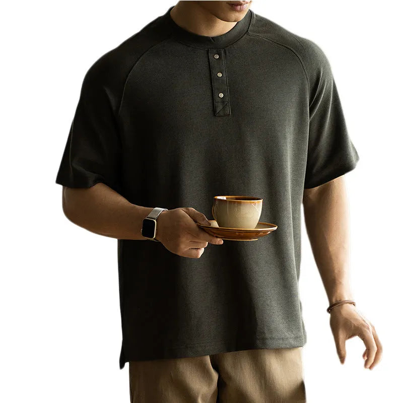 Casual loose-fitting pullover top with raglan sleeves in a terry texture fabric.
