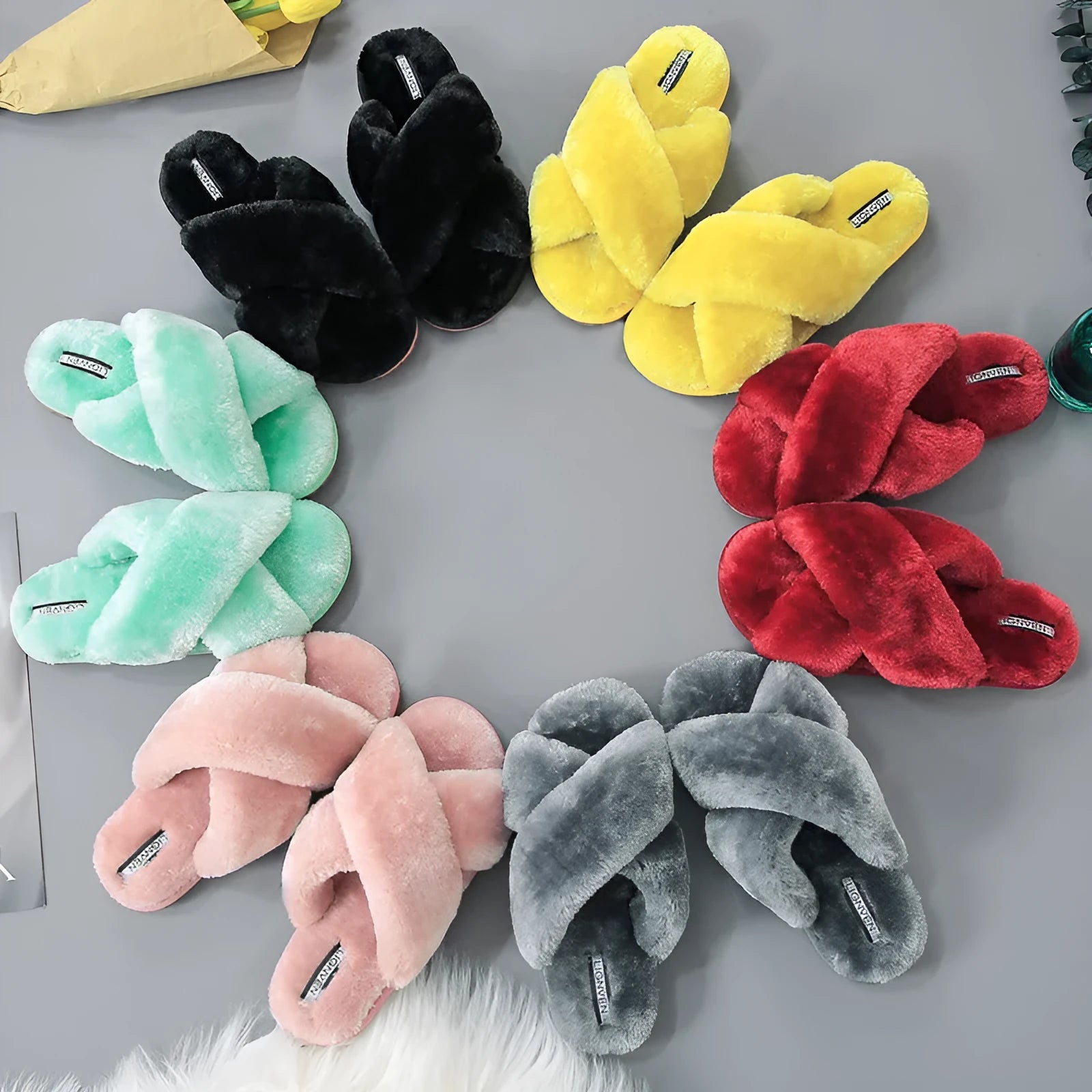 Women's black cross open-toe fur slippers with a patterned non-slip sole.