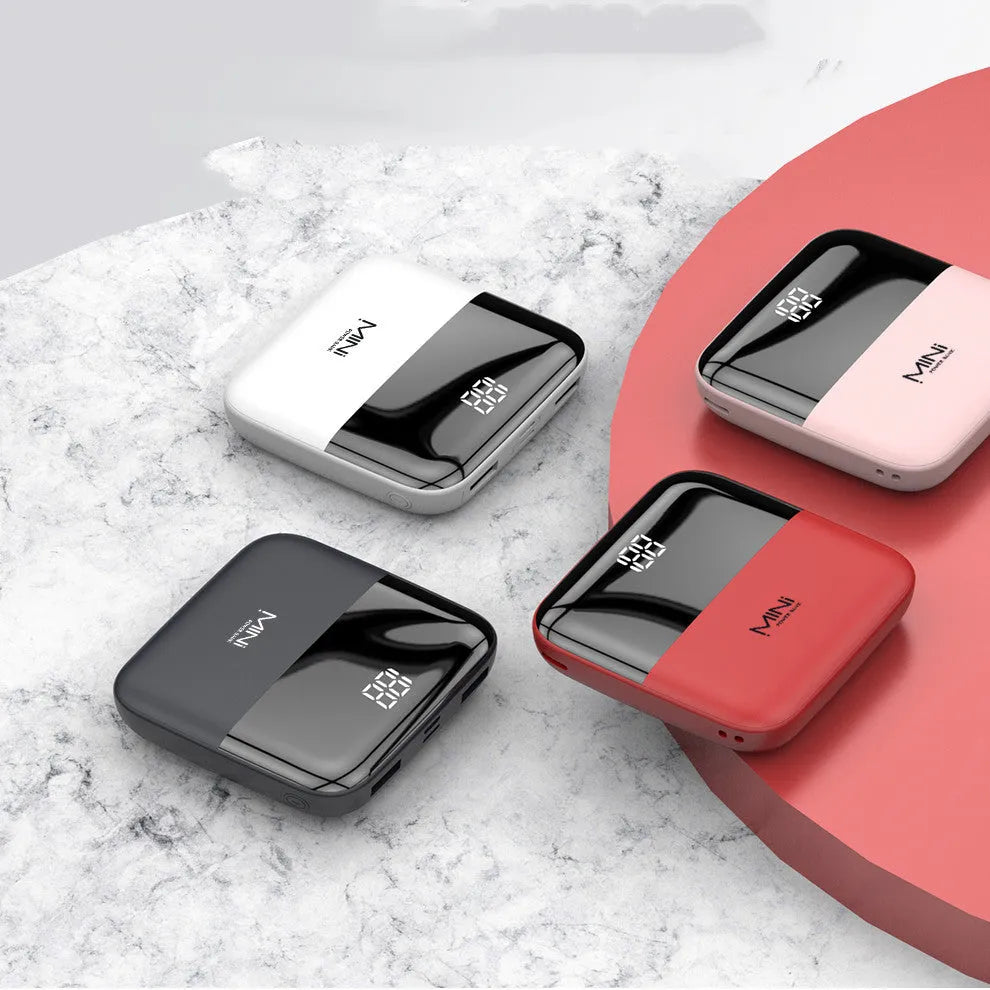 White 10000mAh portable power bank with digital display showing battery percentage and two USB ports.