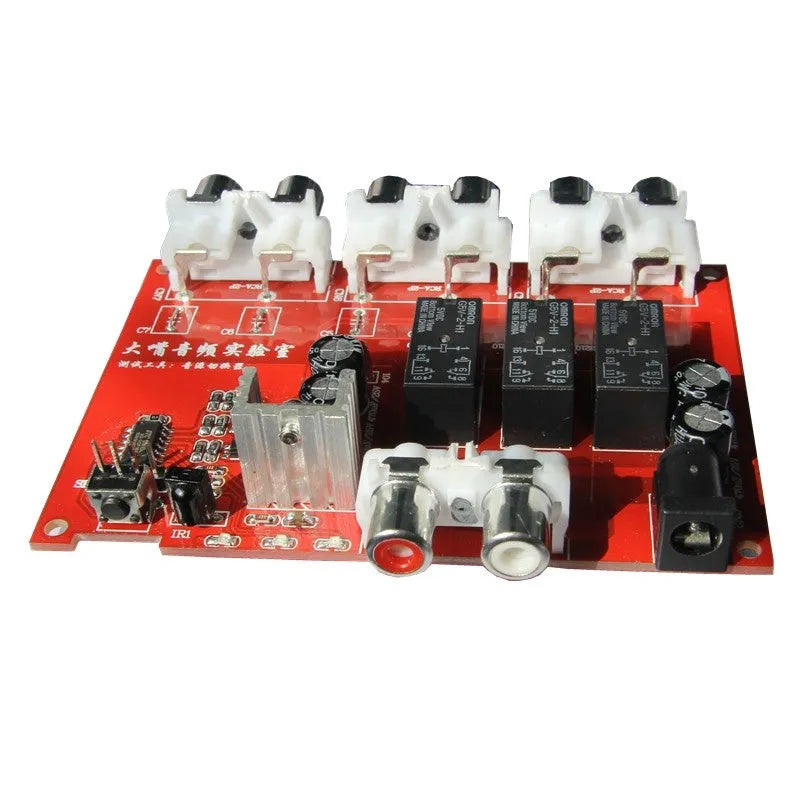 Silver aluminium audio source switch box with remote control for input/output selection.