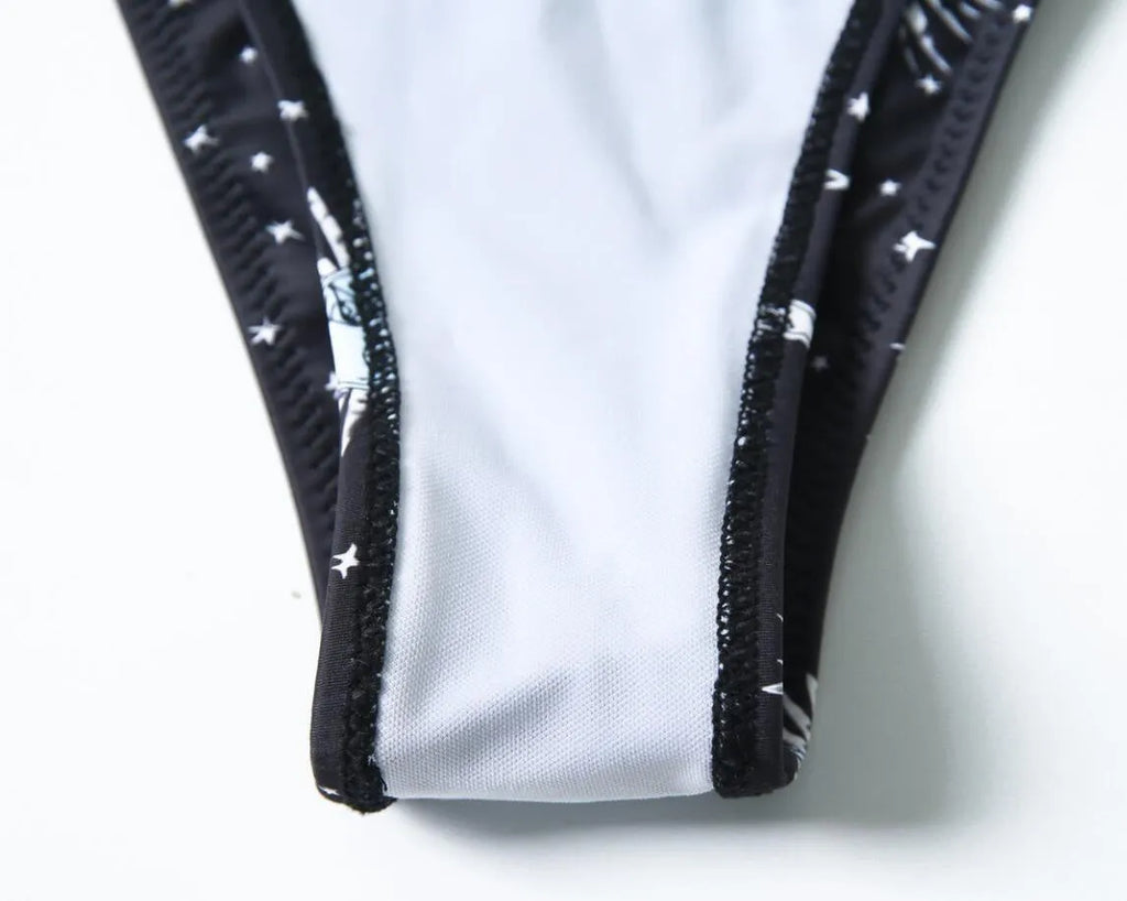 Black printed one-piece swimsuit with backless design and split tube top.