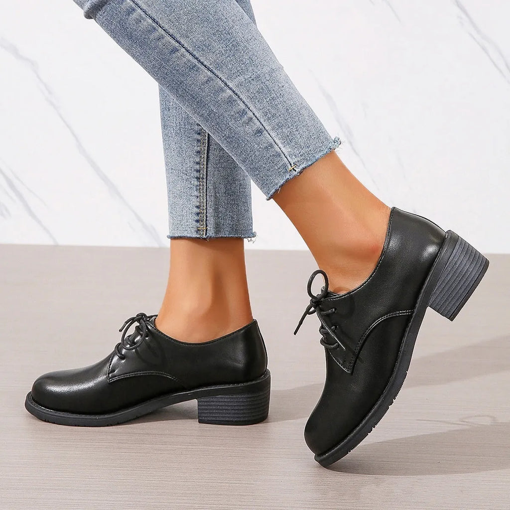 Black women's low-top work shoes with a chunky heel and pointed toe.