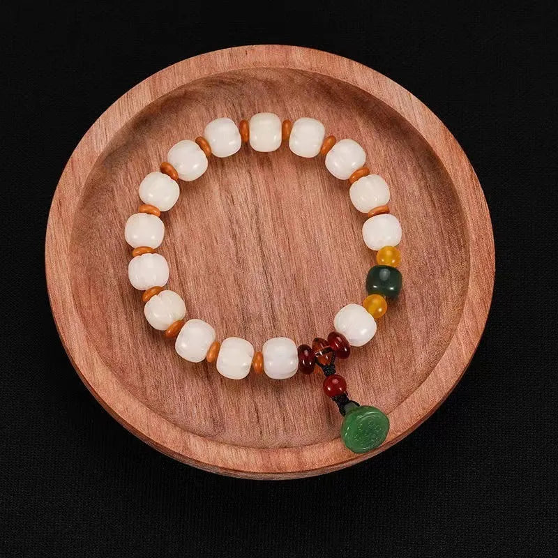 Carved bodhi root pumpkin lotus bracelet with white jade beads and mixed sizing