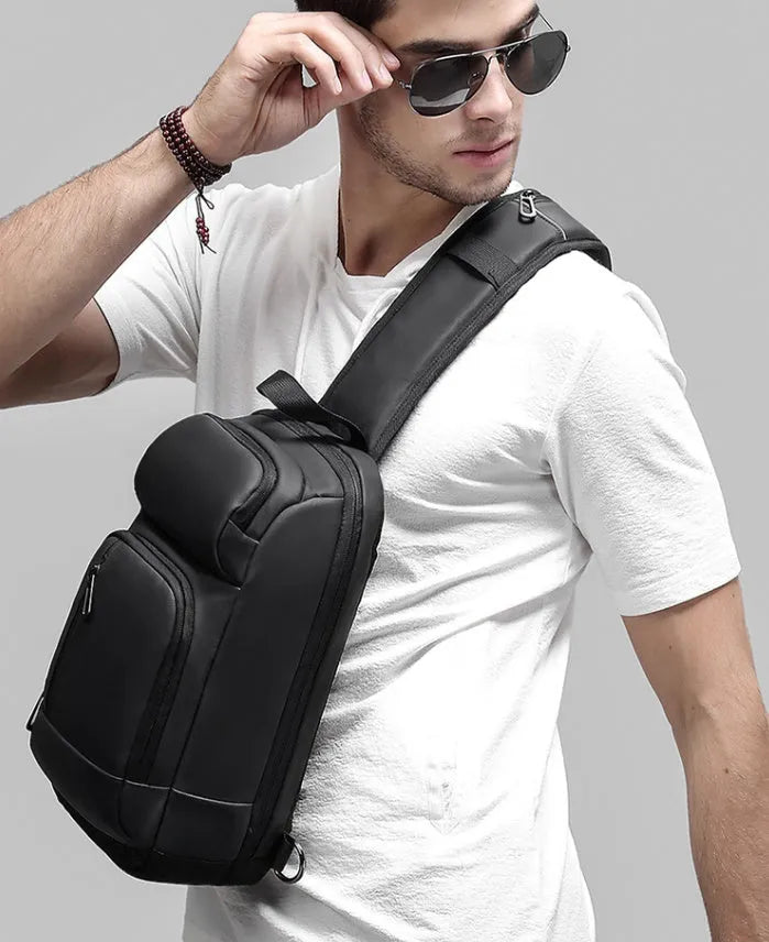 Black medium-sized PVC shoulder bag with zipper, showing internal organiser pockets and an air cushion shoulder strap.