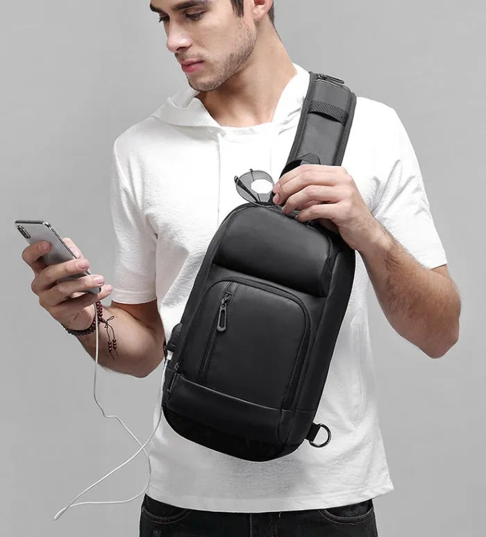 Black medium-sized PVC shoulder bag with zipper, showing internal organiser pockets and an air cushion shoulder strap.