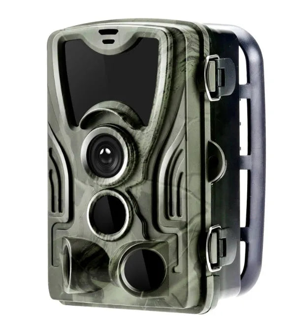 Green cellular trail game camera mounted on a tree trunk for remote deer and wildlife monitoring.