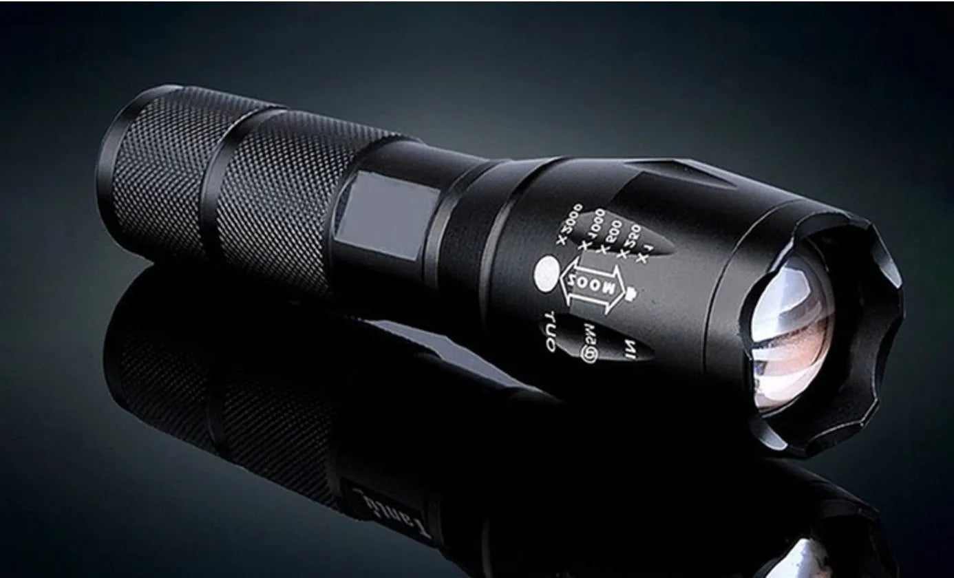 Black aluminium alloy LED zoom flashlight with adjustable focus ring and antiskid texture.