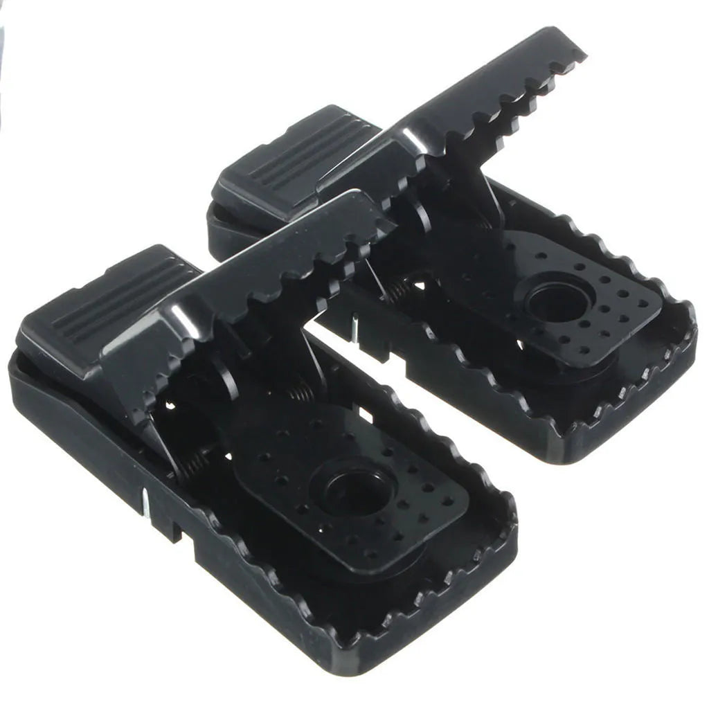 Six black plastic snap mousetraps laid out, each measuring 11 cm long.