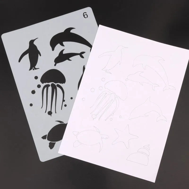 A set of white drawing stencils with various cut-out shapes, laid out on a flat surface.