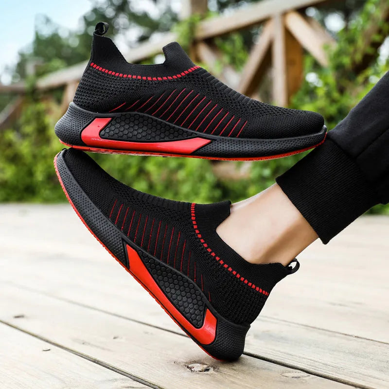 Men's black and white striped mesh slip-on sneakers with lace-up front on a white background