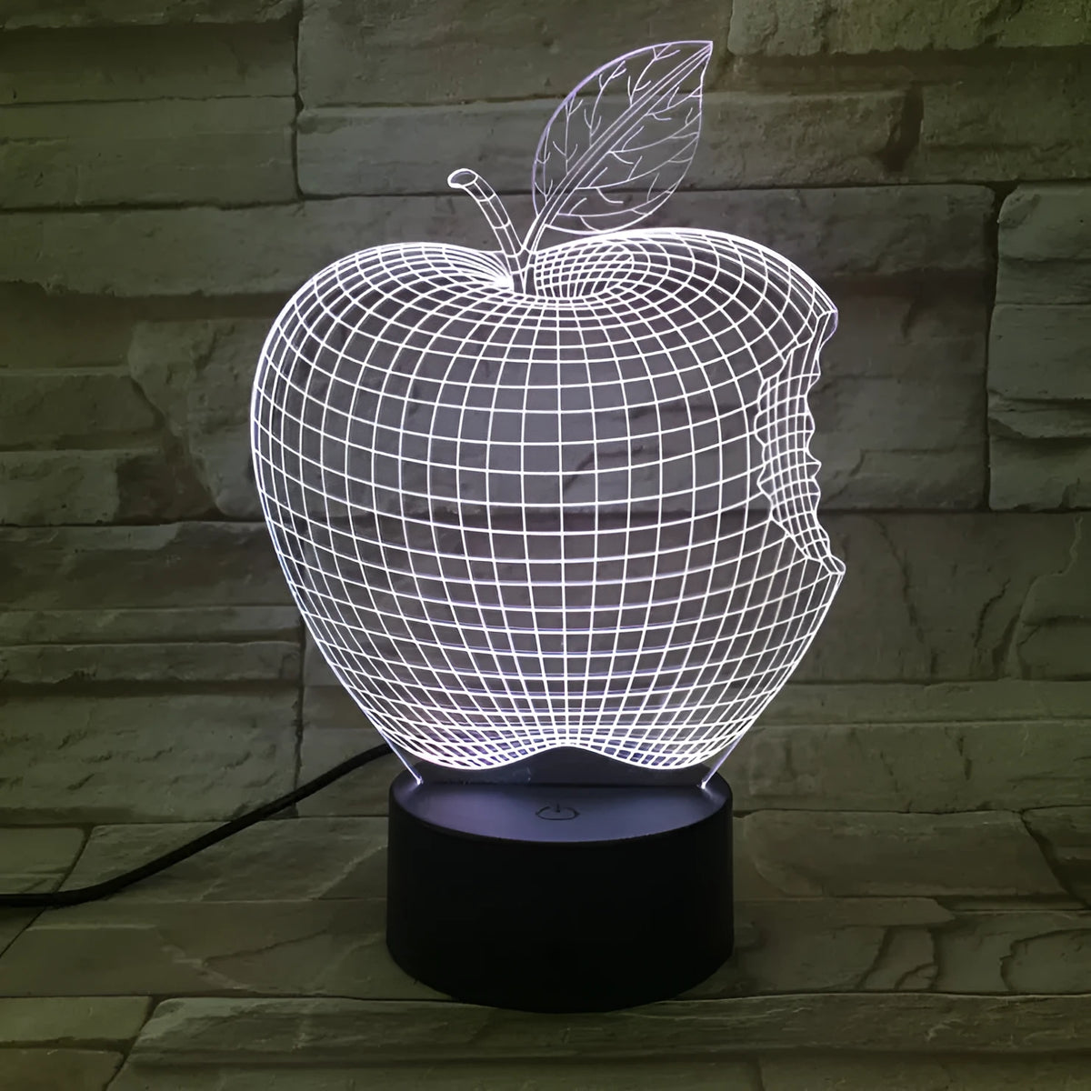 3D fruit-shaped decorative night light with colourful LED illumination on a table.