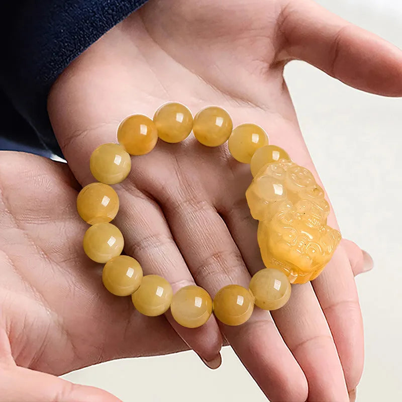 Hand-carved golden thread jade money coin bracelet with jade beads in two size options.