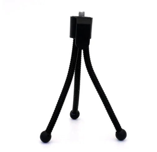 Small silver iron mini tripod with ball head, folded to compact size next to a smartphone.