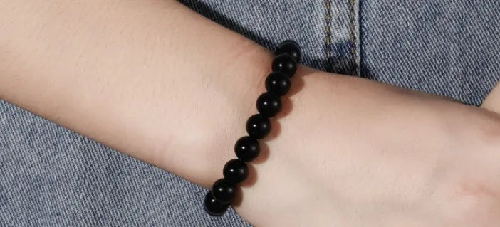 Geometric black onyx bead bracelet for women with elastic cord.