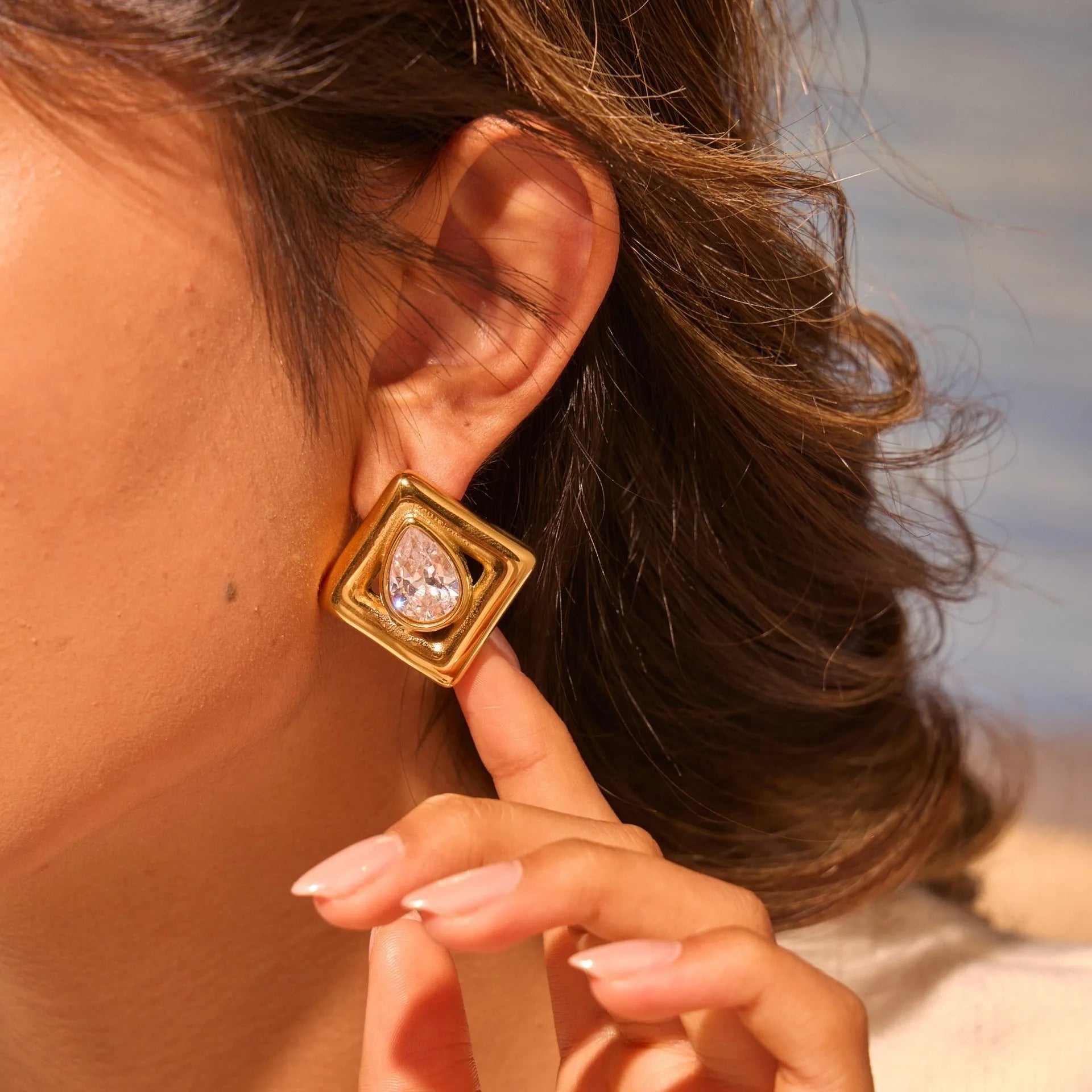 Gold geometric stud earrings with water drop zircon design on stainless steel