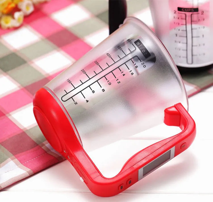 Green electronic digital measuring cup with LCD display on handle showing weight measurement.