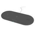 Black and white 3-in-1 wireless charging station for Apple-compatible phone, watch, and earbuds on a desk.