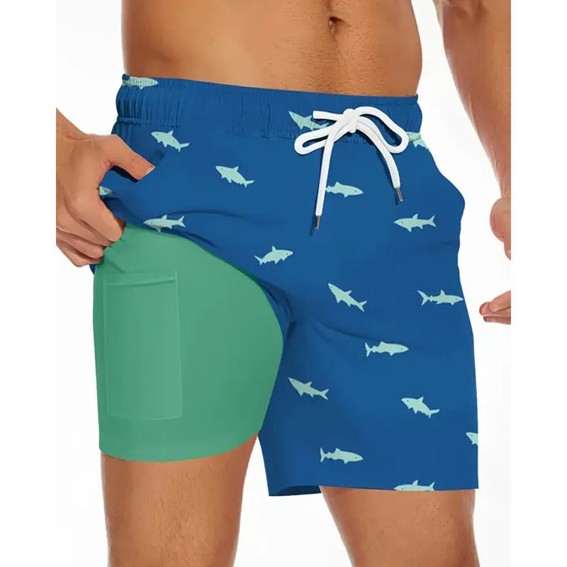 Man wearing loose light blue beach pants on shore, showing relaxed fit and casual style.