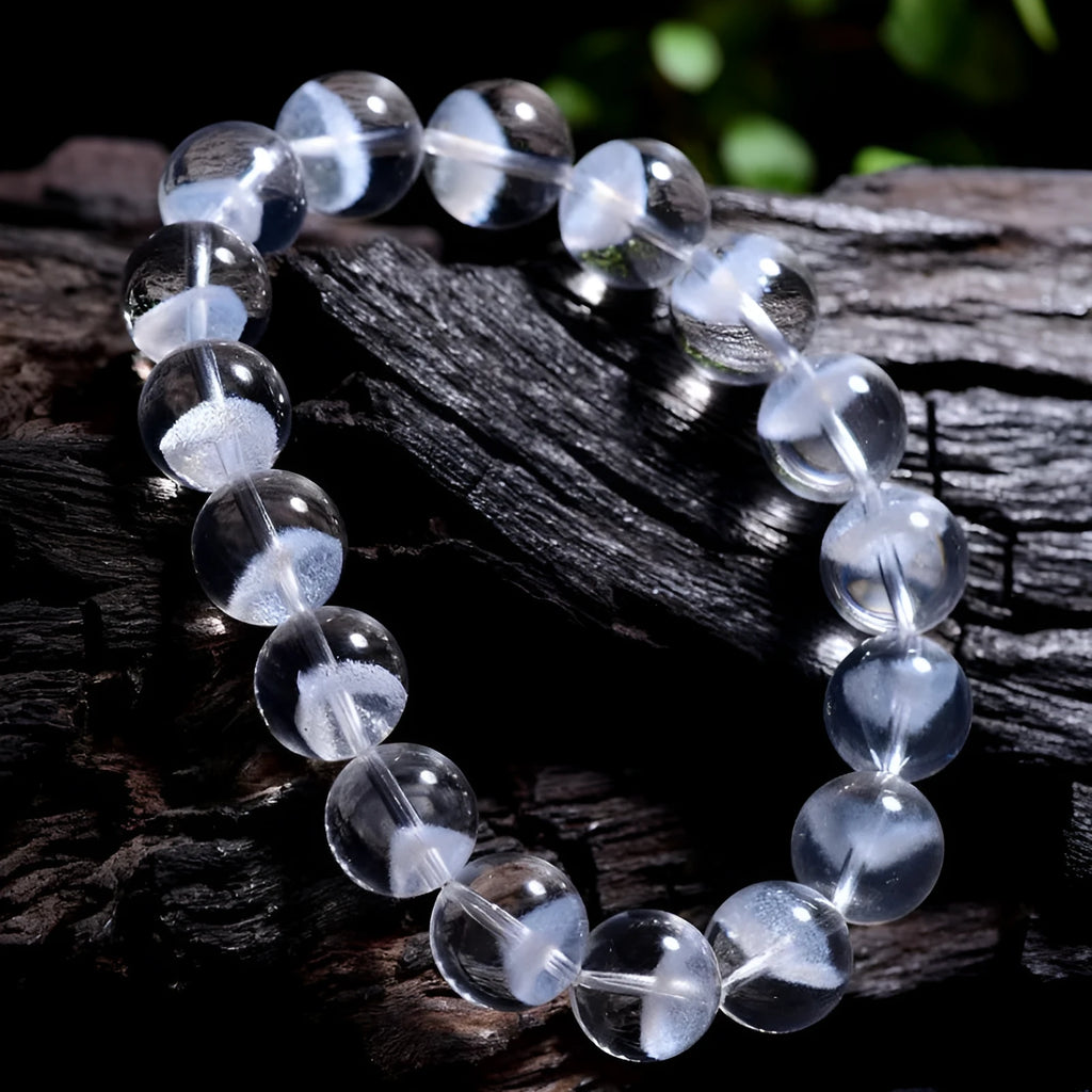 Women's white crystal ghost pyramid bracelet with Ruyi design elements on a wrist.