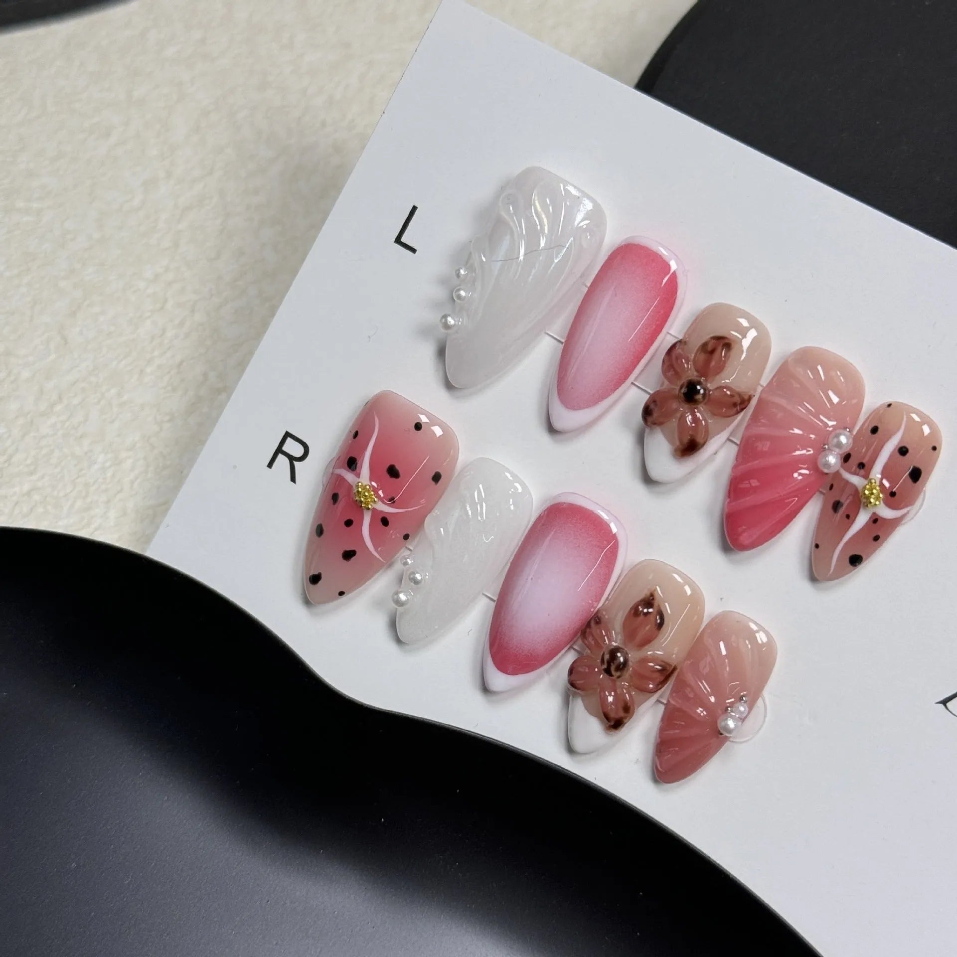 Hand-painted three-dimensional carved nail beauty patches in candy colours on an almond-shaped nail.