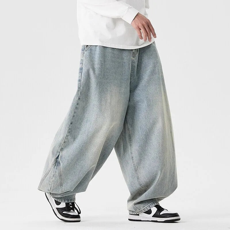 Man wearing black plus-size baggy denim jeans with a straight leg and low waist.