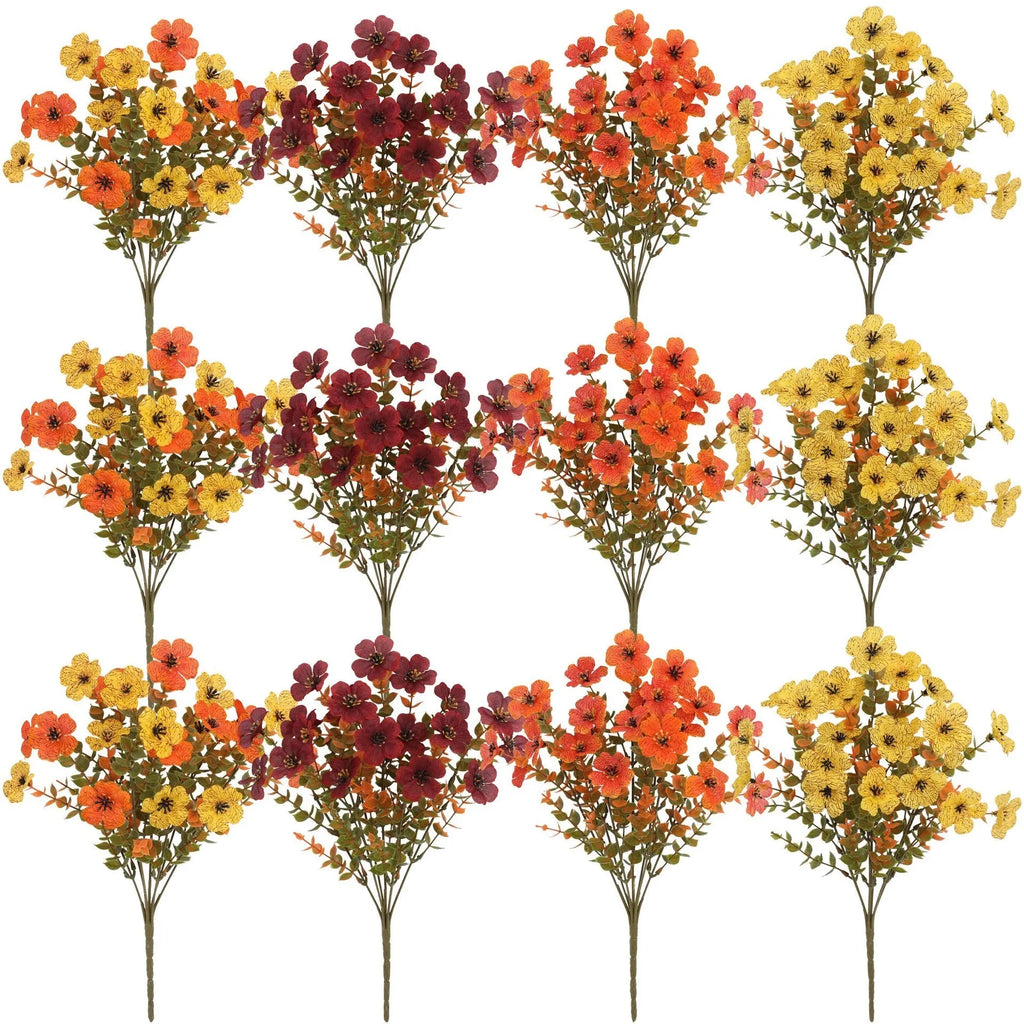 Artificial flower bouquet in autumn orange, red, and yellow colours for home or wedding decoration.