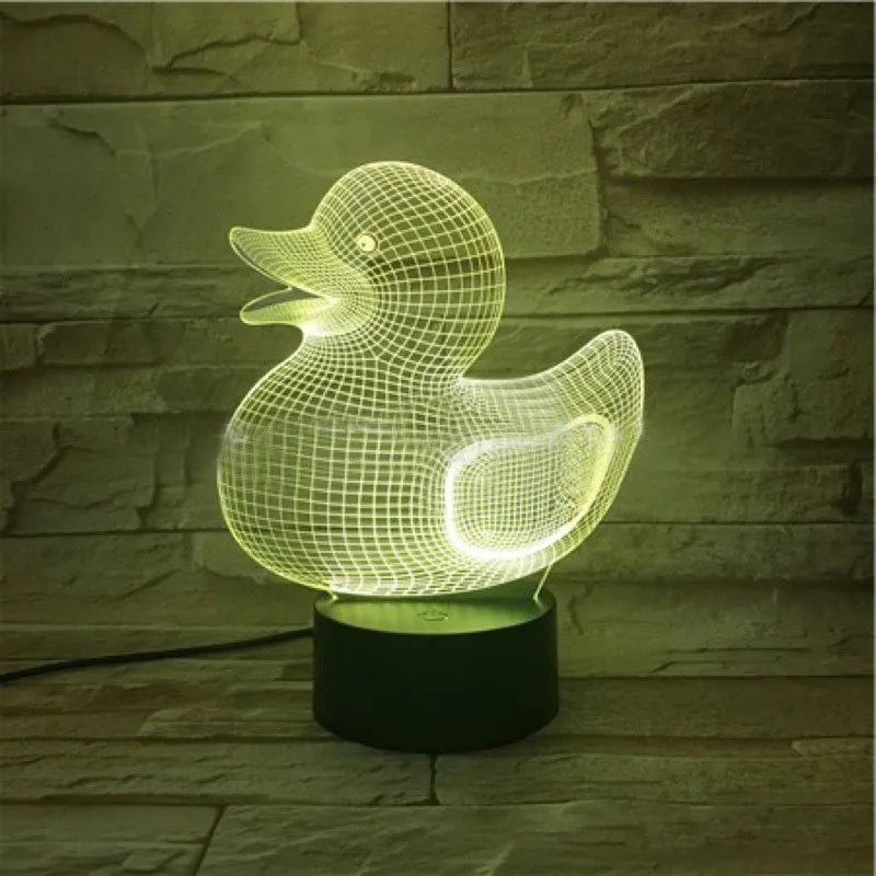 Little Yellow Duck 3D LED night light on a table showing its colourful illuminated display and remote control.