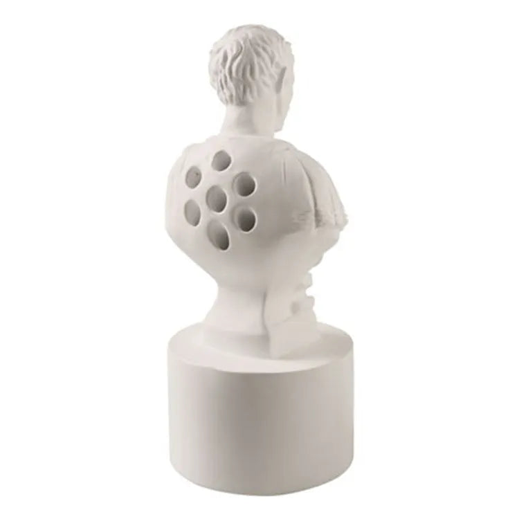 White American style character model pen holder made from synthetic resin on a desk.