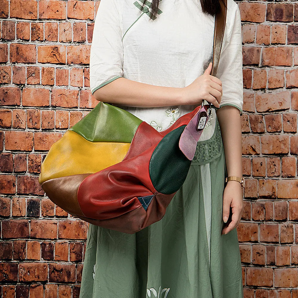 Brown cowhide leather stitching rubbing travel bag with crossbody strap.