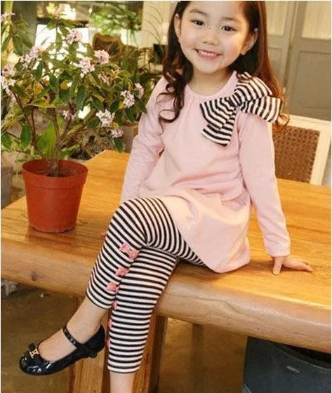 A pink cotton blend clothing set for a young girl, shown on a hanger.