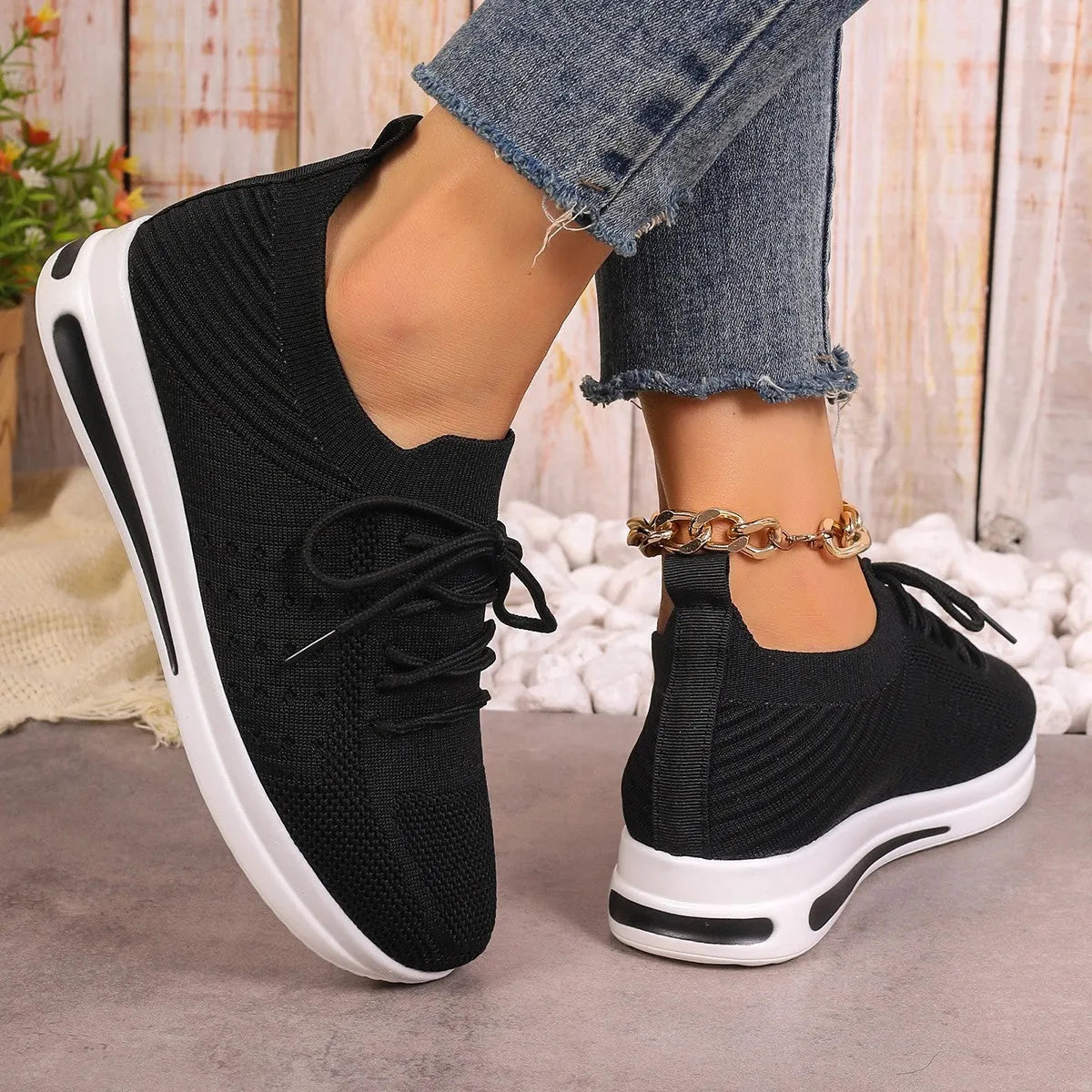Women's low-top red casual sneakers with round toe and white lace-up front on a plain background.