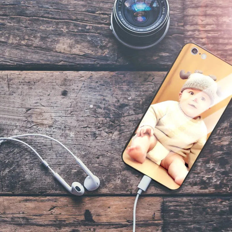 Slim patterned iPhone case with raised edges protecting a smartphone.