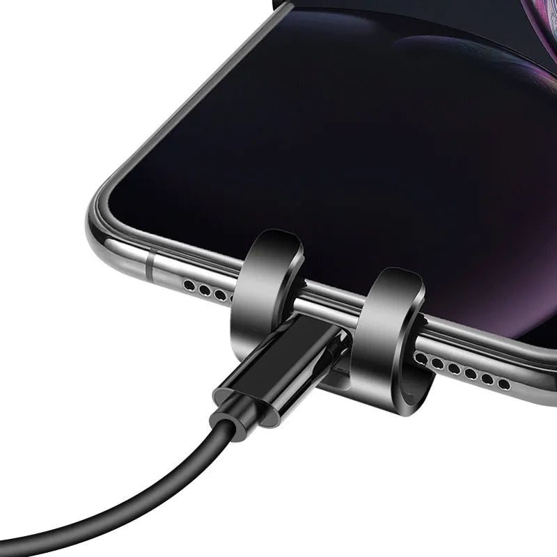 Black S4 gravity mirror car phone bracket attached to a car air conditioning vent, holding a mobile phone.