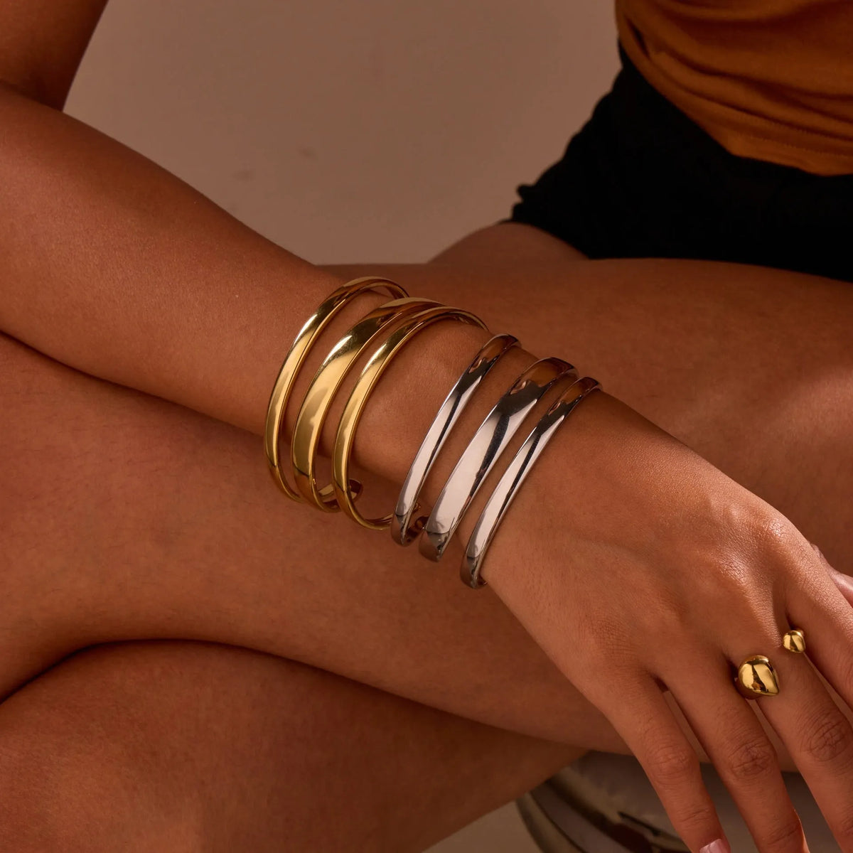 Geometric line stainless steel bracelet for women in gold tone or steel finish.