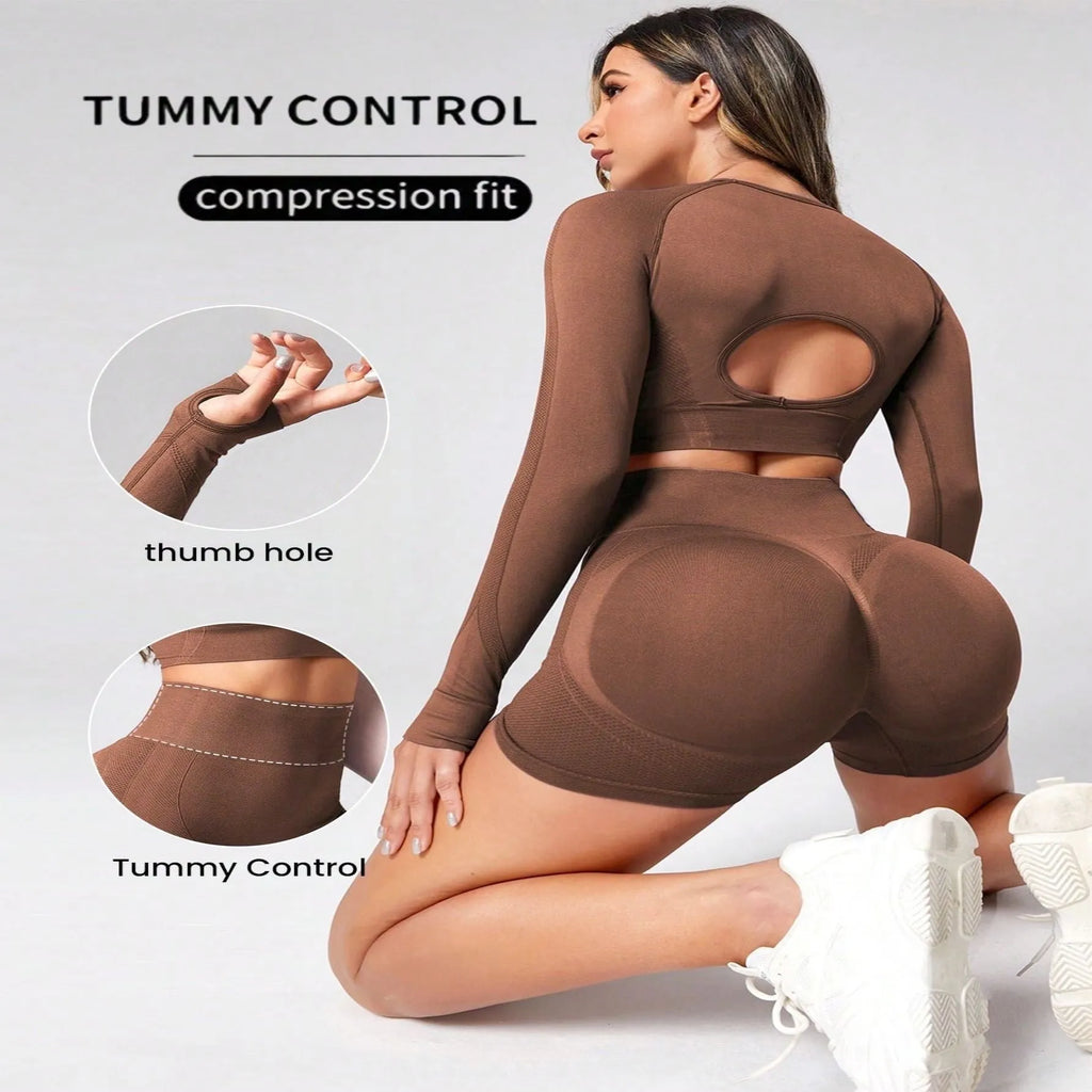 Women's black yoga suit set showing long sleeve pullover top and high-waisted tight-fitting pants.