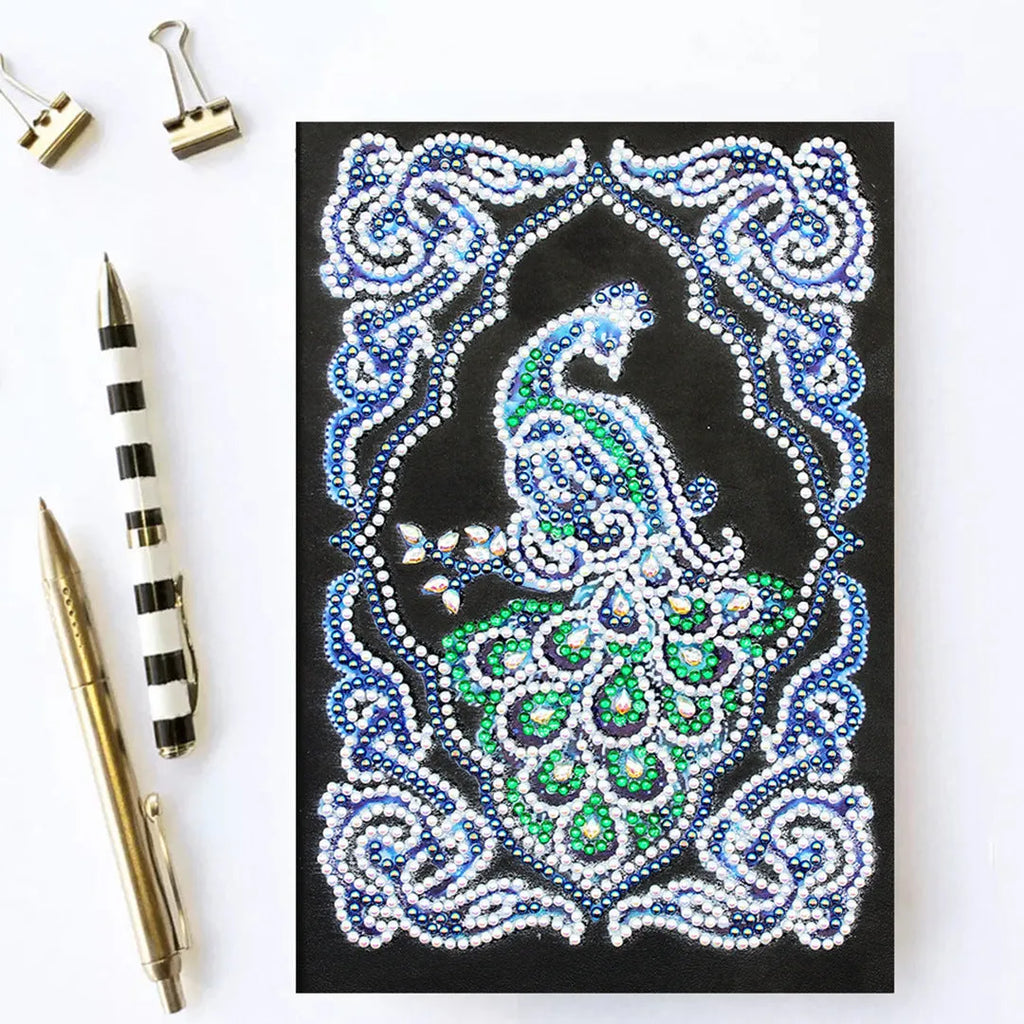 Black A5 diamond painting notebook with peacock design showing shaped and bright drill beads