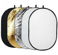 Collapsible 5-in-1 photography reflector with gold, silver, white, black, and translucent surfaces folded with carrying bag