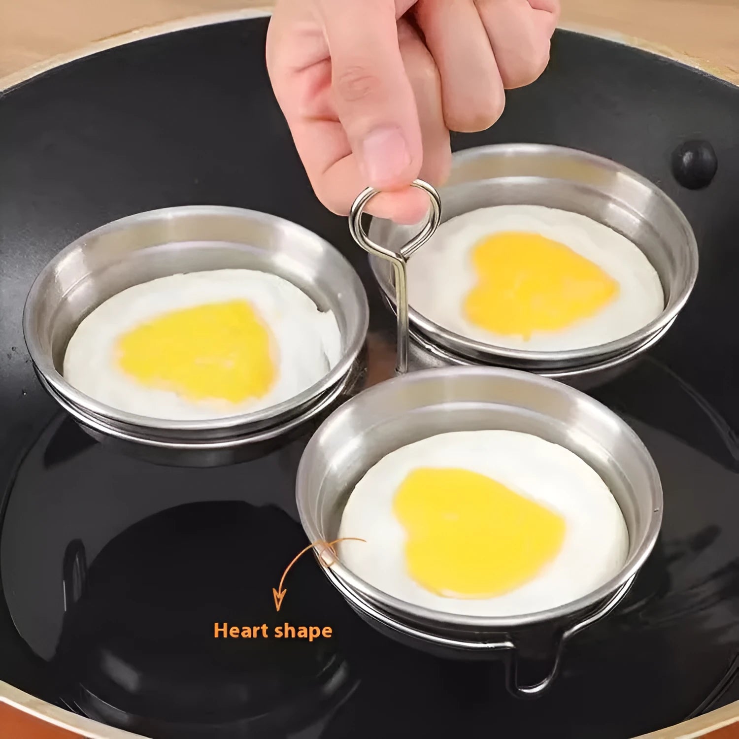 Stainless steel heart-shaped egg steamer with cooking wells for decorative boiled eggs